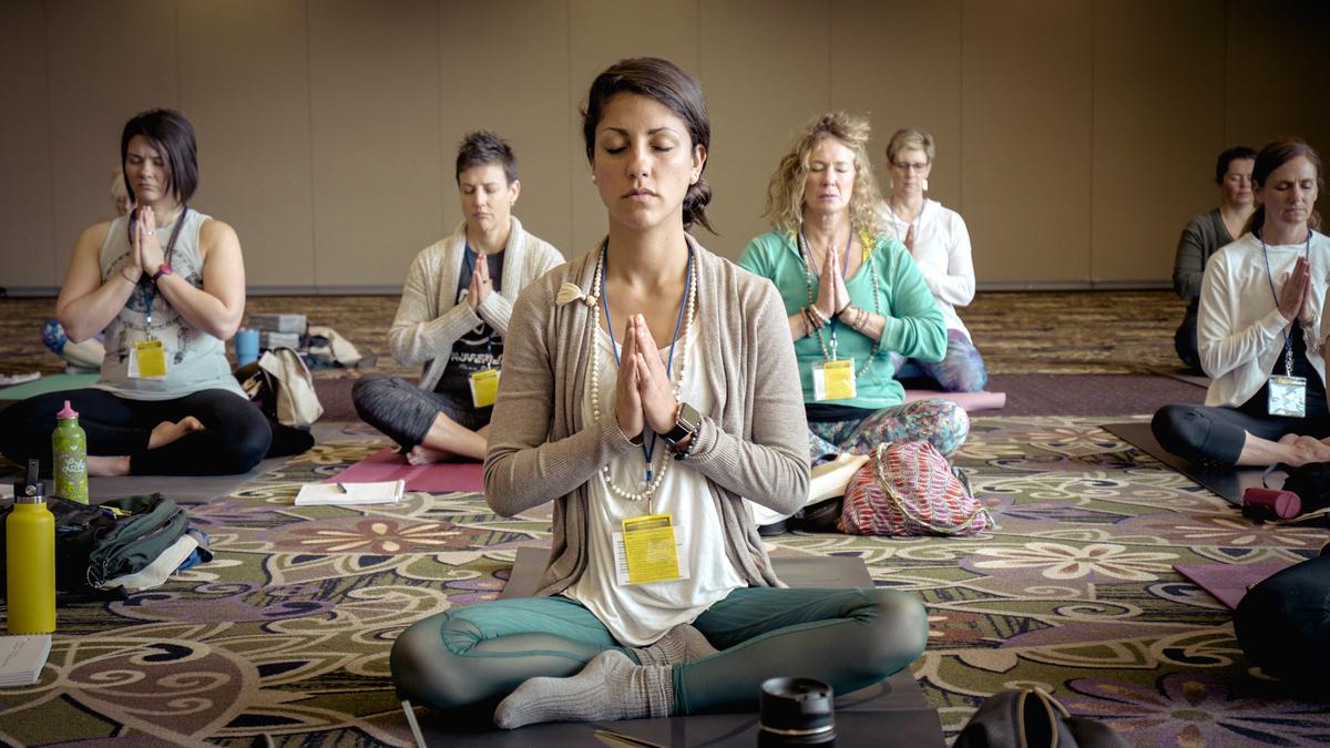 A diverse group of people doing yoga poses together, connecting and finding inner balance.